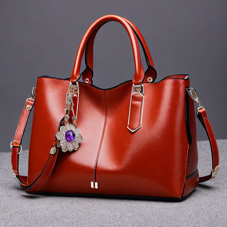 Red Leather Handbag with Detachable Strap and Floral Brooch