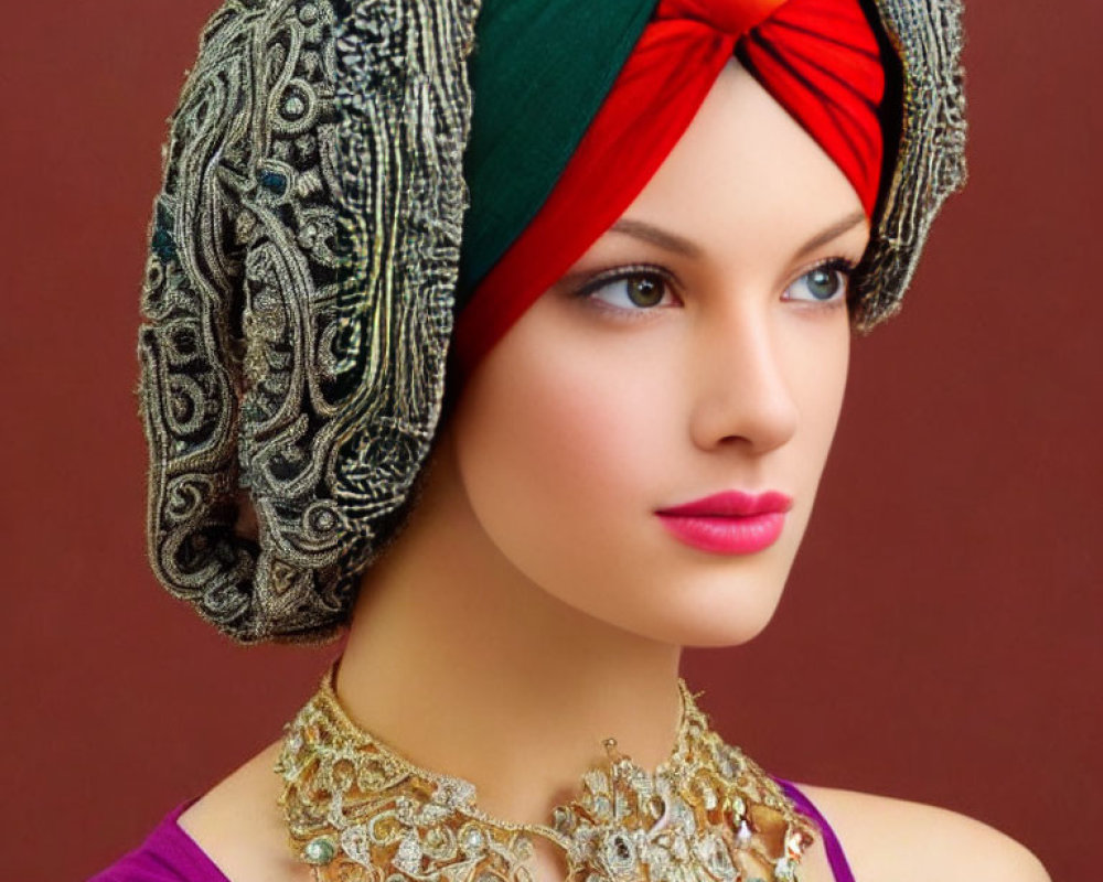 Portrait of Woman with Striking Blue Eyes in Multicolored Turban and Gold Necklace on Maroon