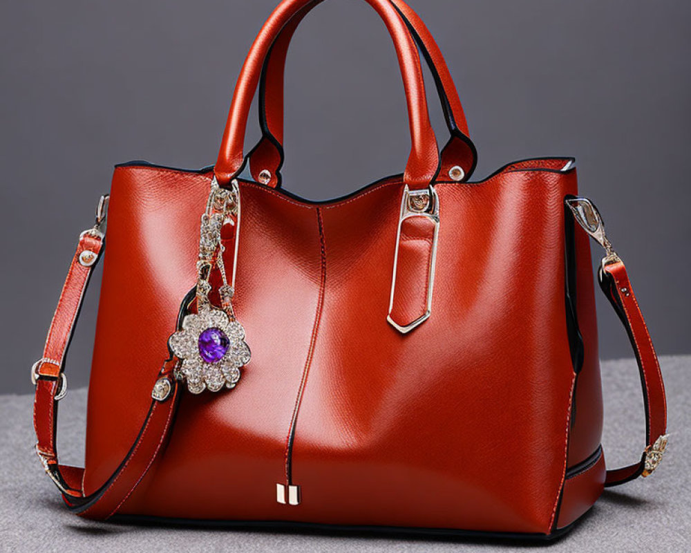 Red Leather Handbag with Detachable Strap and Floral Brooch