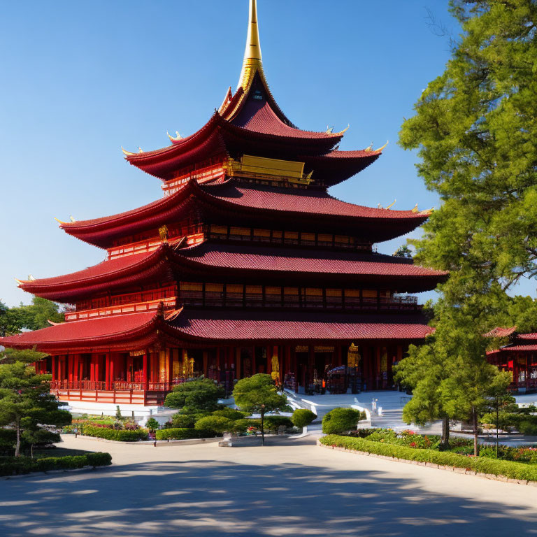 Traditional Red and Gold Pagoda Amid Green Trees and Blue Sky