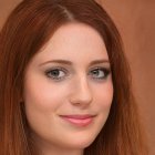 Young woman with floral headband and brown hair against brick wall.