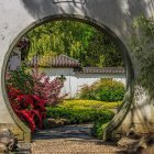 Ornate circular gateway reveals fantastical landscape with figure, vibrant flora, and twilight sky