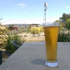 Colorful surreal landscape with beer glass and townscape.