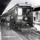 Vintage Striped Train Conductor Beside Station Platform