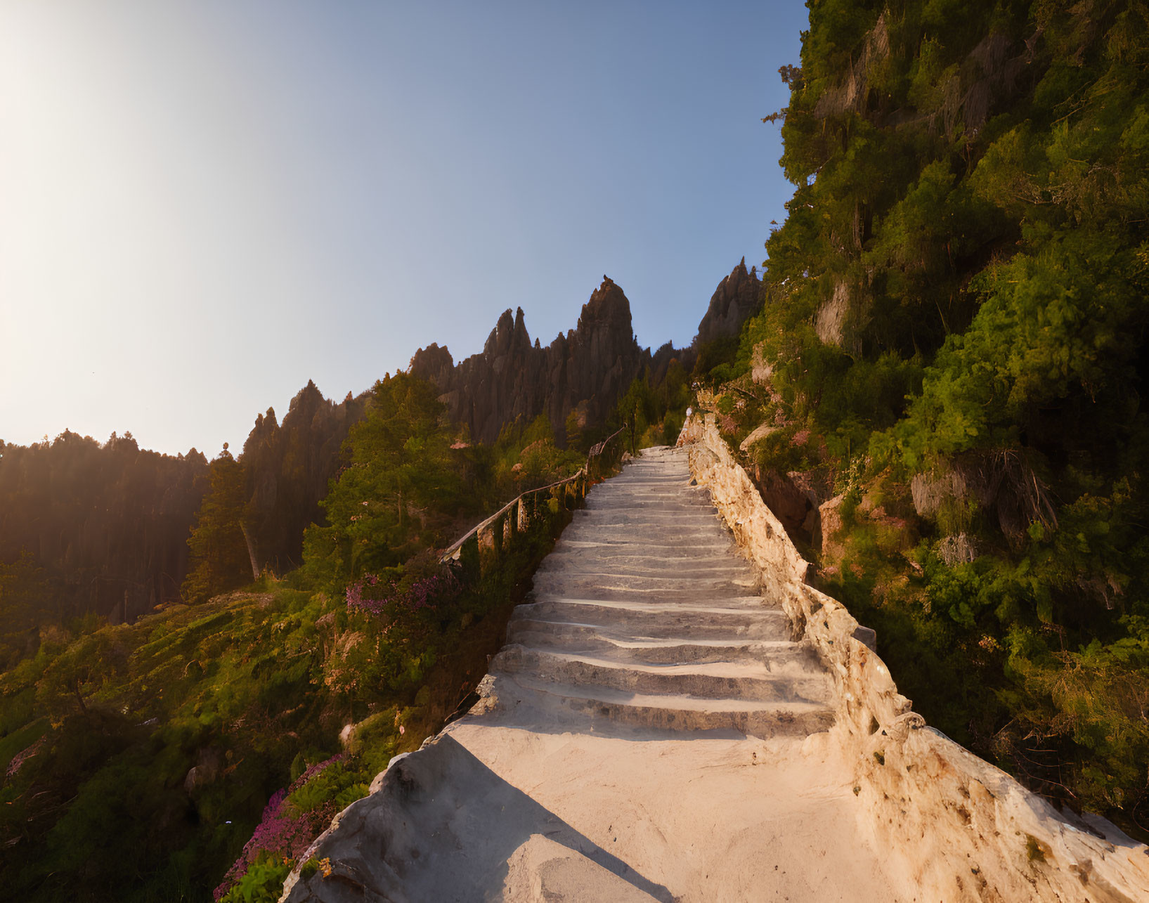 Rugged hillside with stone steps and sharp peaks in warm sunlight