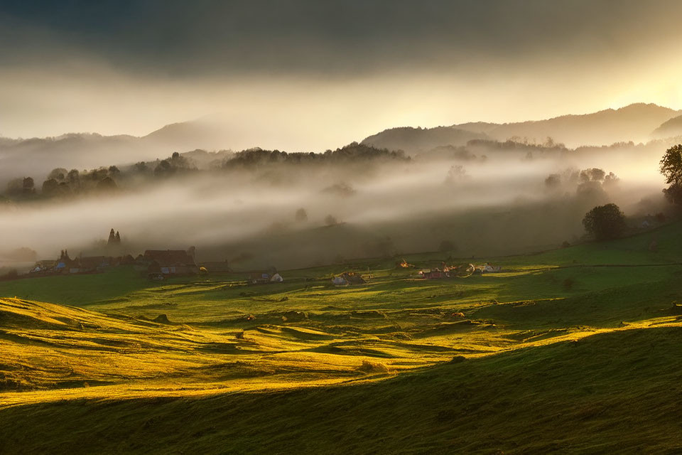 Scenic sunset over green hills with fog, village, and trees