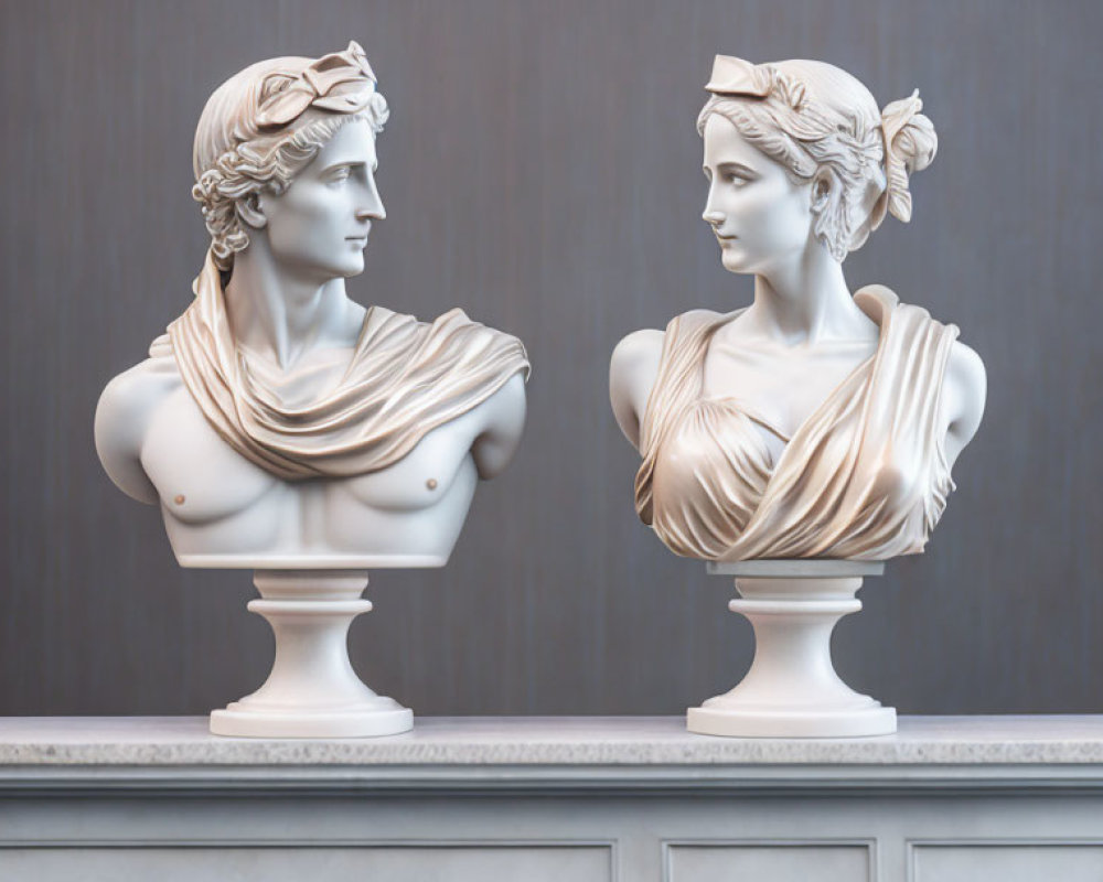 Classical marble busts of mythological figures on pedestal against grey background