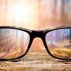Sunglasses on Forest Floor Reflecting Vibrant Trees