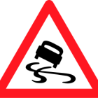 Red Car Splashing Through Water on Wet Road with Warning Triangle