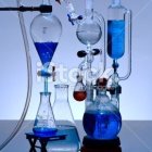 Interconnected Glass Vessels with Glowing Blue Liquid in Alchemy Lab