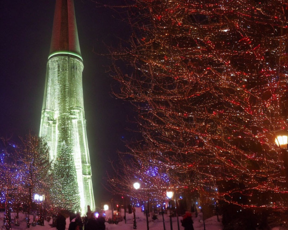 Snowy Night Scene: People, Red-Lit Trees, Green Tower