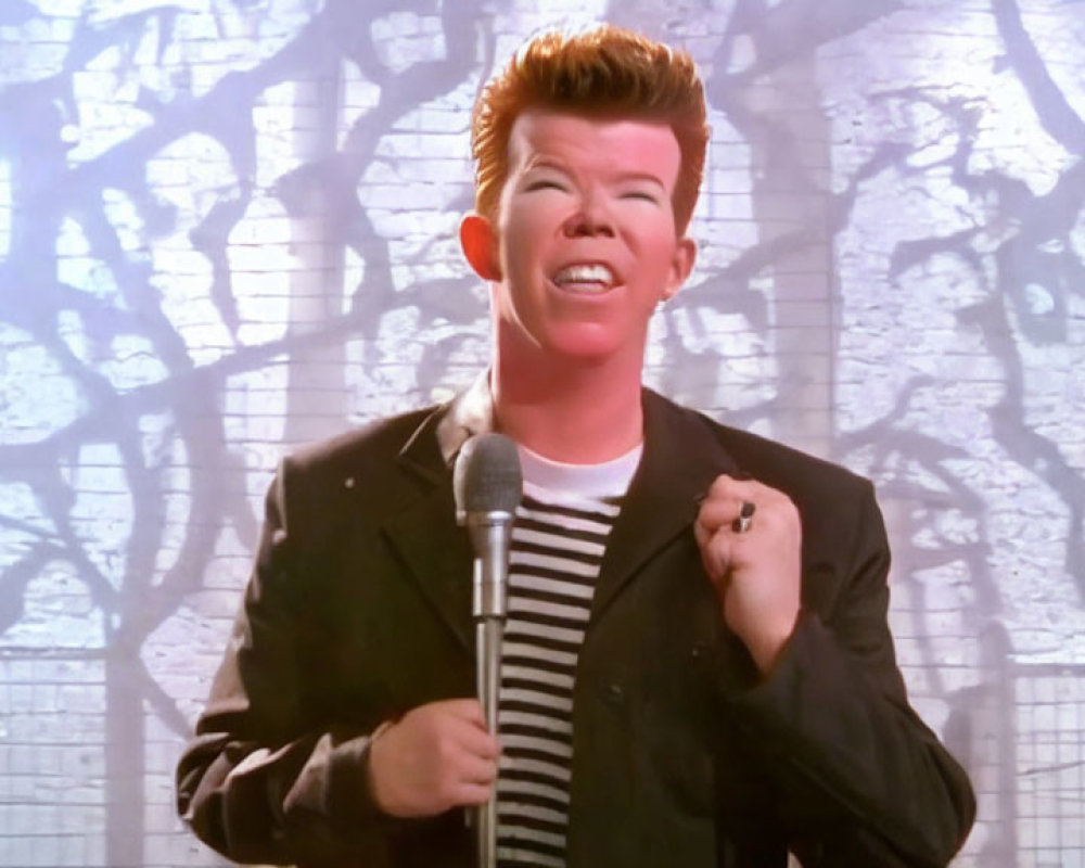 Red-haired person in striped shirt singing with microphone against shadowy tree background
