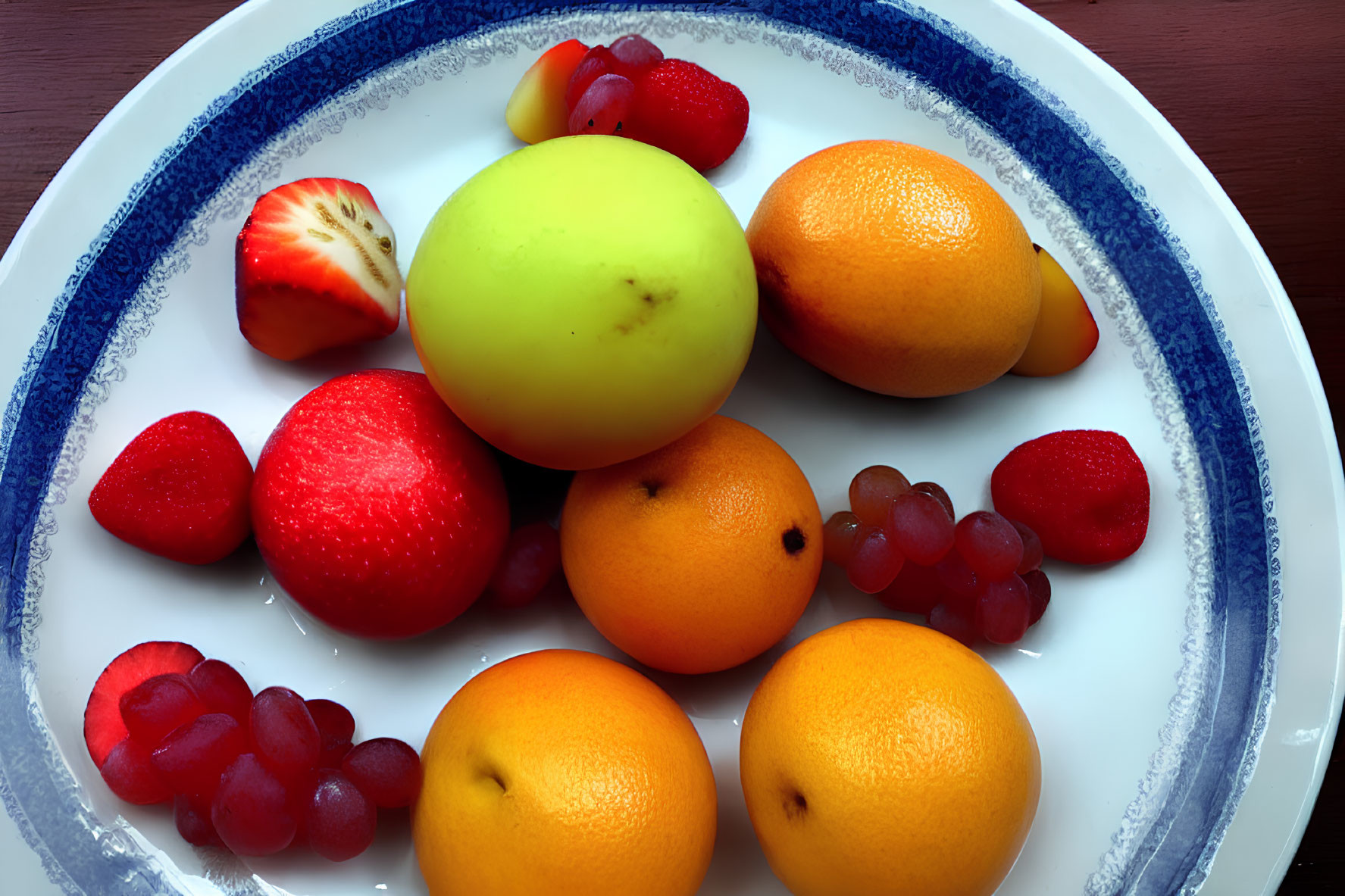 Colorful Fruit Mix on White Plate with Blue Trim