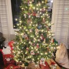 Colorful Christmas tree with lights, ornaments, star, gifts, robot, and spaceship