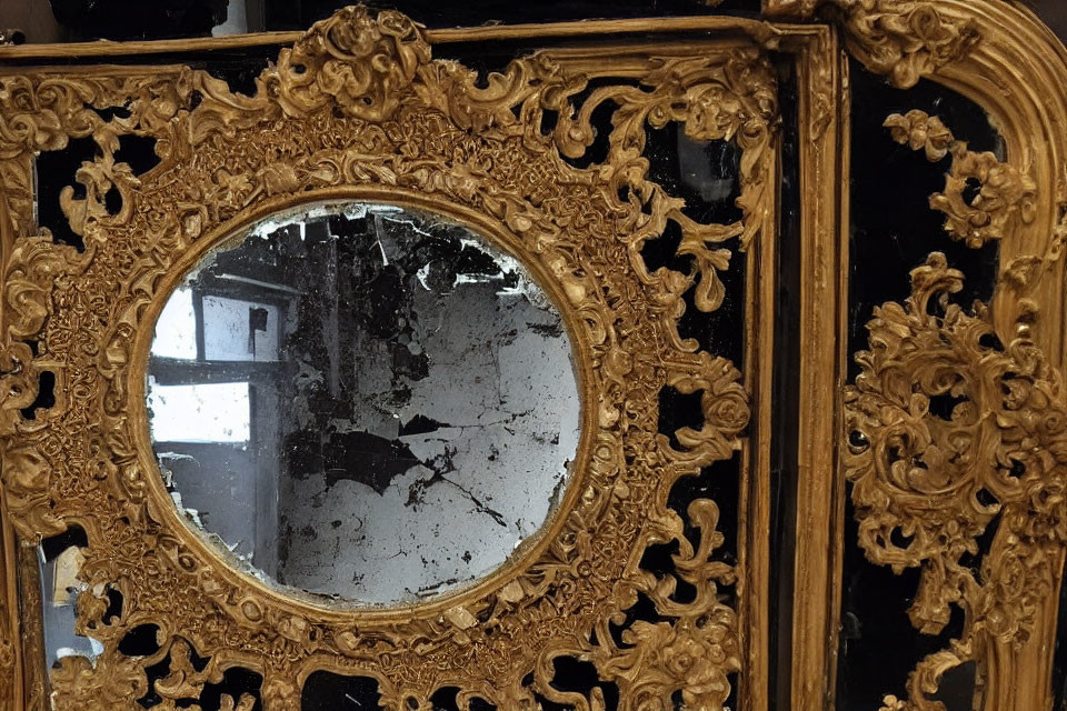 Intricate Gold-Framed Mirror with Signs of Age and Wear