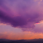 Colorful purple and golden sunset over cloud-streaked sky