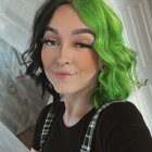 Vibrant digital portrait of young woman with green hair and colorful makeup