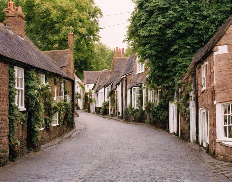 Traditional brick houses on quaint cobbled street in historical village