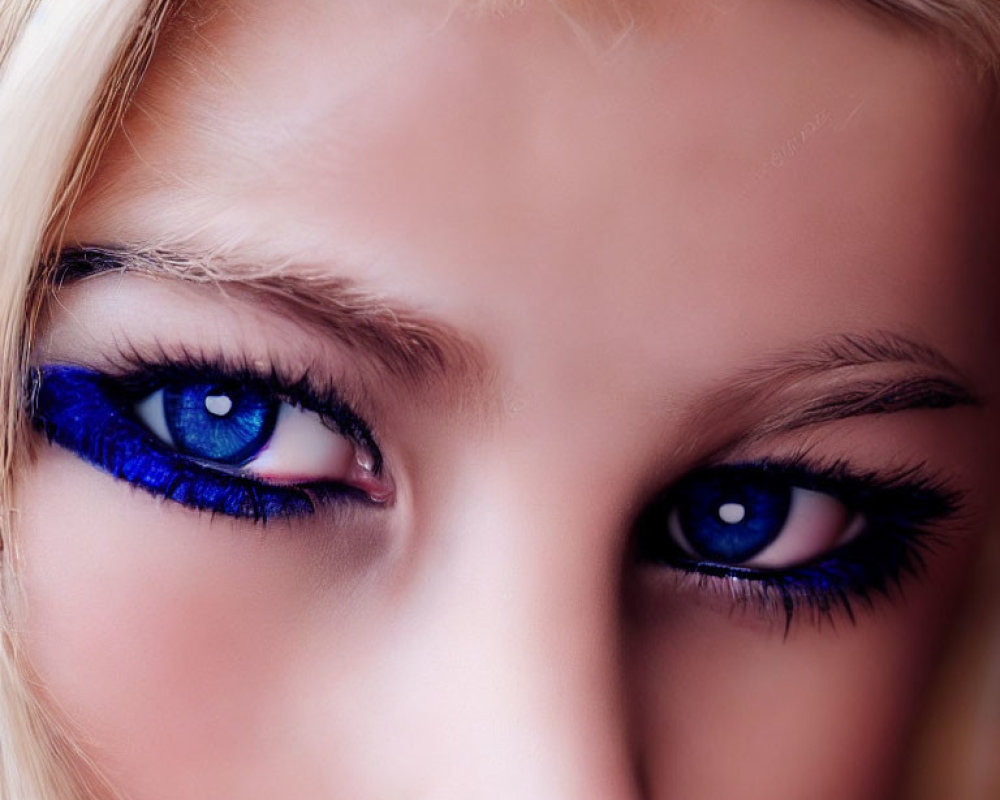 Close-Up of Person with Striking Blue Eyes and Bold Blue Makeup