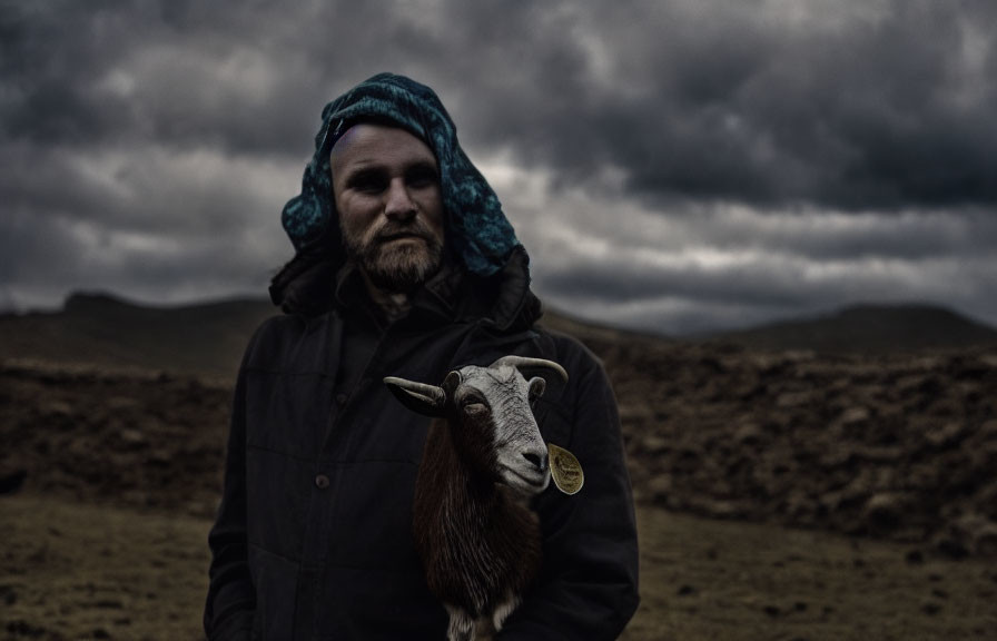 Person in Knit Cap Holding Goat Outdoors Under Overcast Sky