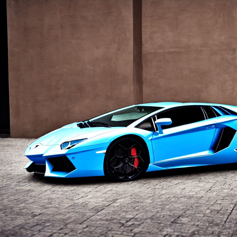 Bright Blue Lamborghini Sports Car with Sharp Angles and Black Rims