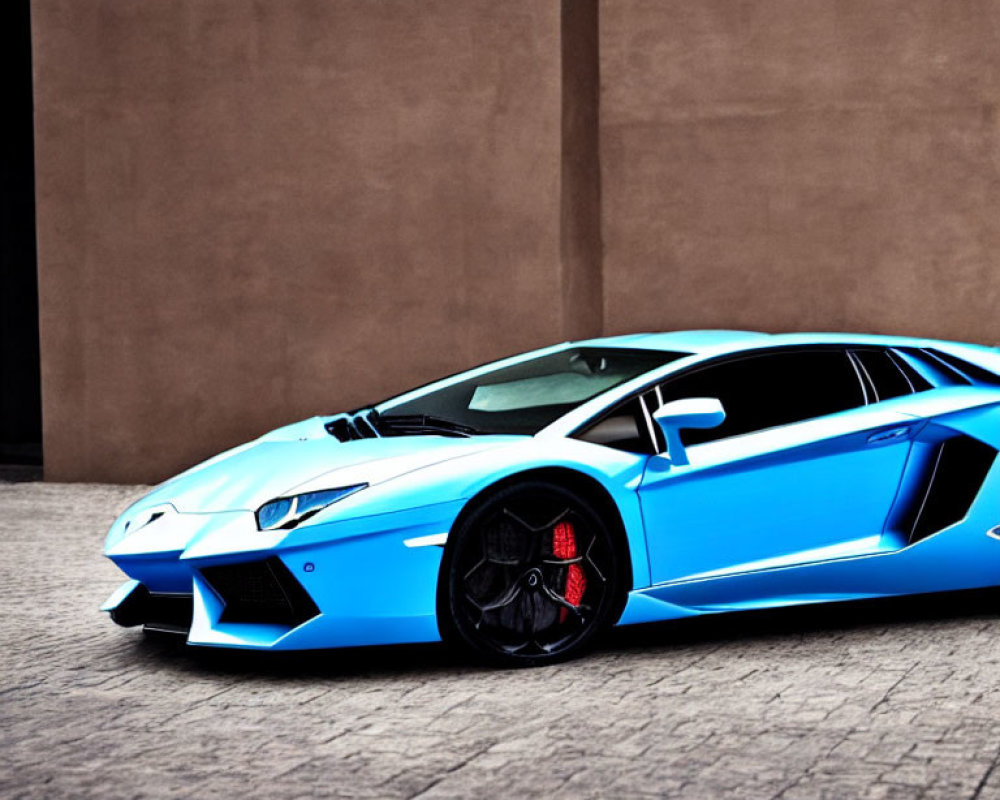 Bright Blue Lamborghini Sports Car with Sharp Angles and Black Rims