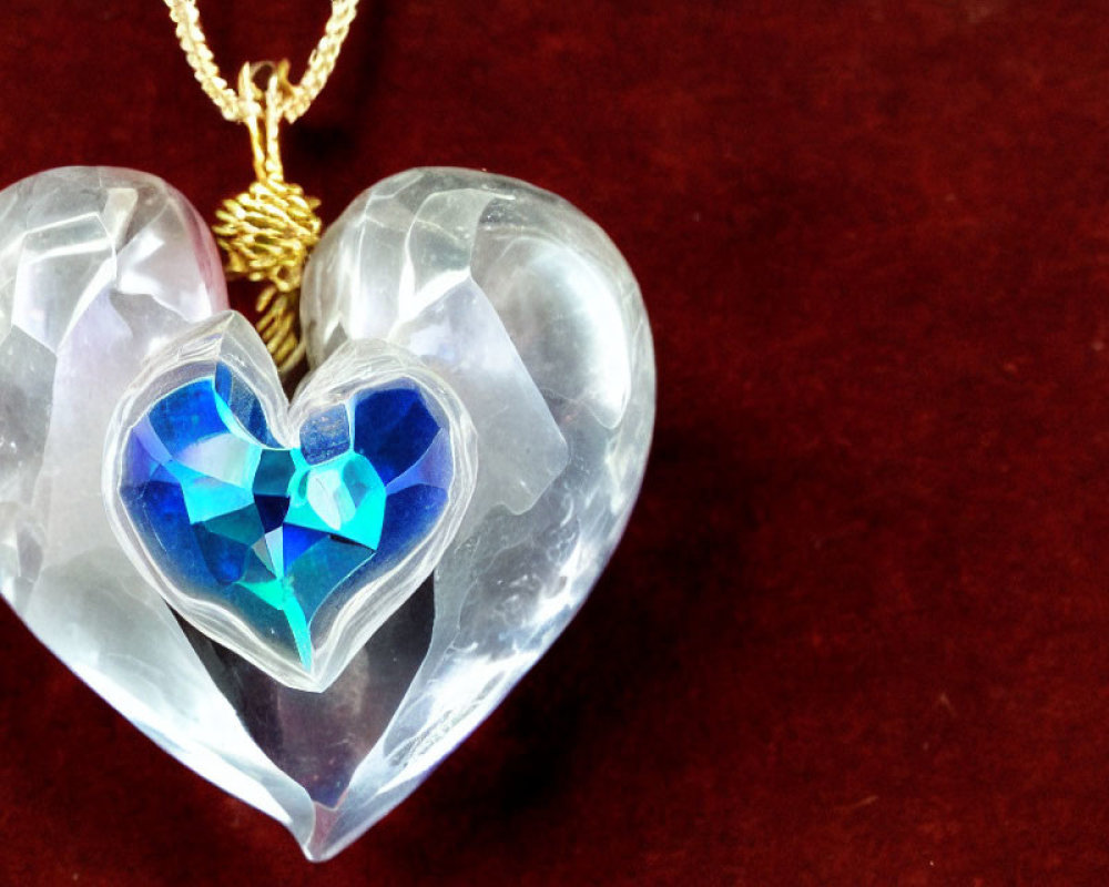 Heart-shaped crystal pendant with blue heart, gold chain, red background