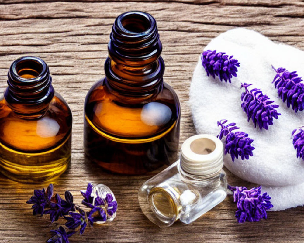 Amber Glass Bottles with Essential Oils and Lavender Sprigs on Wooden Surface