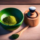 Green bowl with matcha powder, bamboo whisk, and spoon on wooden surface