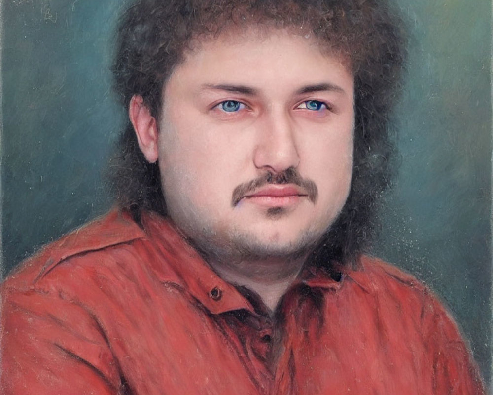 Man with Curly Hair, Mustache, and Beard in Red Shirt Portrait on Muted Background