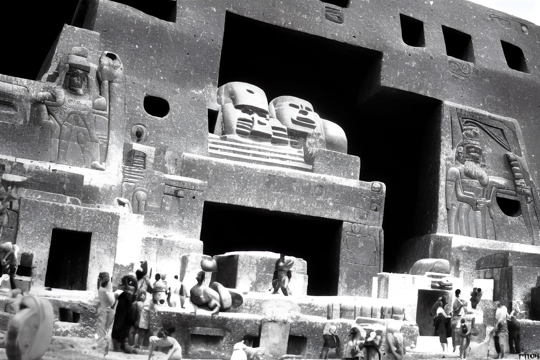 Monochrome image of detailed ancient Egyptian miniature building with hieroglyphs and statues.