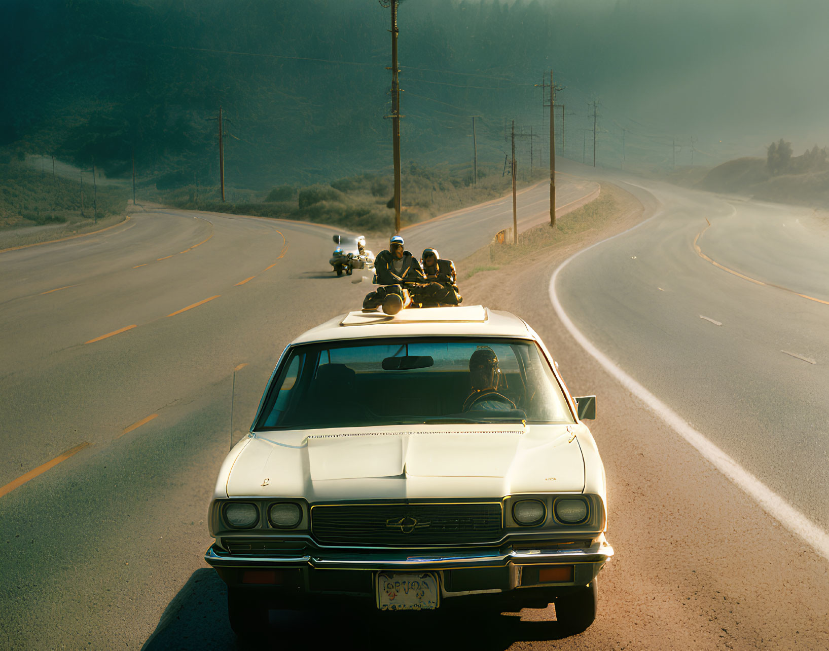 Vintage Car on Hazy Road with Motorcyclists in Serene Landscape