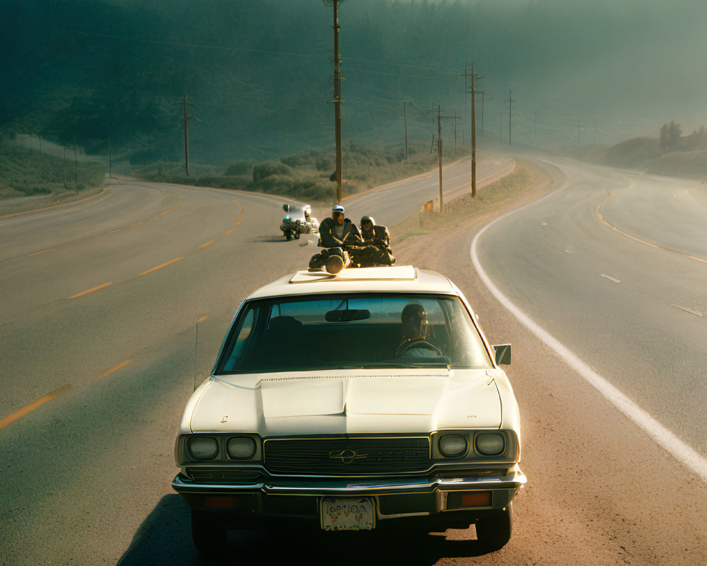 Vintage Car on Hazy Road with Motorcyclists in Serene Landscape