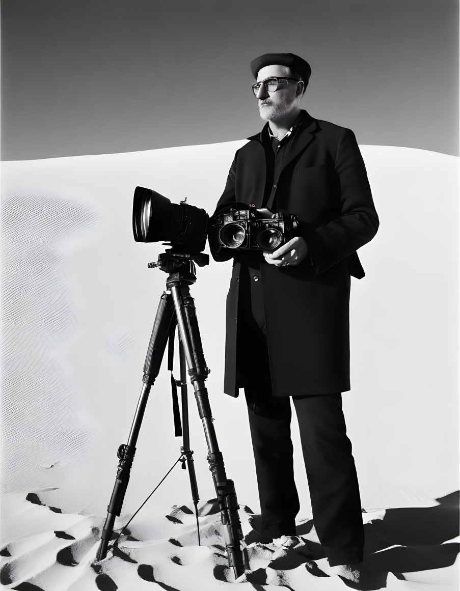 Photographer in hat and glasses with cameras in sandy setting