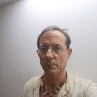 Native American man in traditional attire against misty background