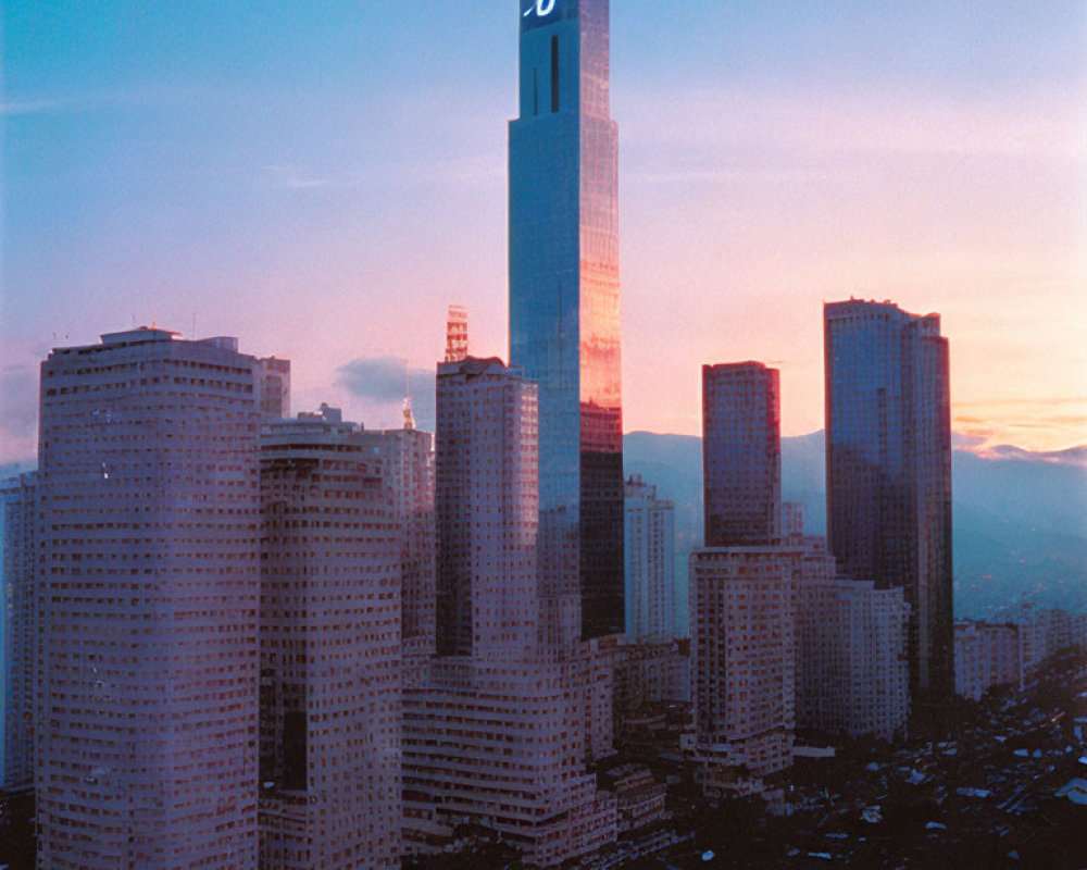 City skyline at sunset with tall building and skyscrapers.