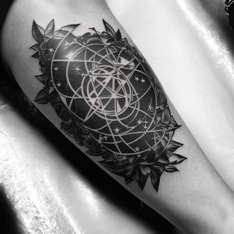 Monochrome photo of intricate pentagram tattoo on arm