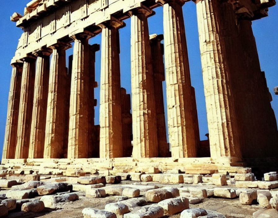 Ancient Greek temple ruins with Doric columns under clear sky