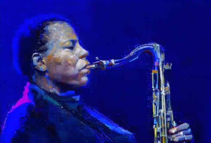 Saxophonist playing against deep blue backdrop