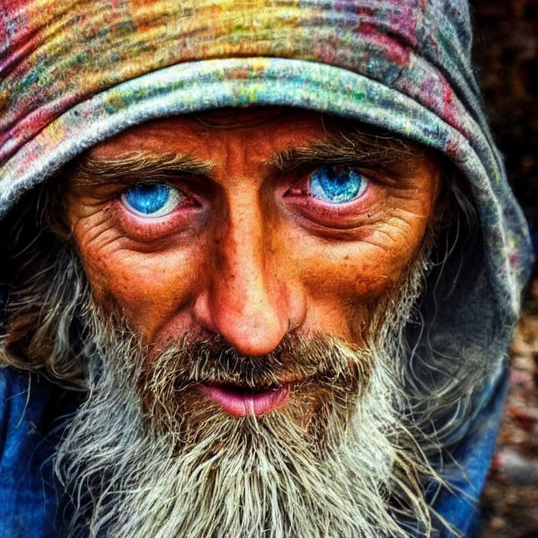 Close-Up Portrait of Man with Blue Eyes and Grizzled Beard wearing Striped Headwrap