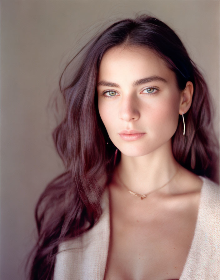 Portrait of Woman with Long Wavy Hair and Striking Blue Eyes