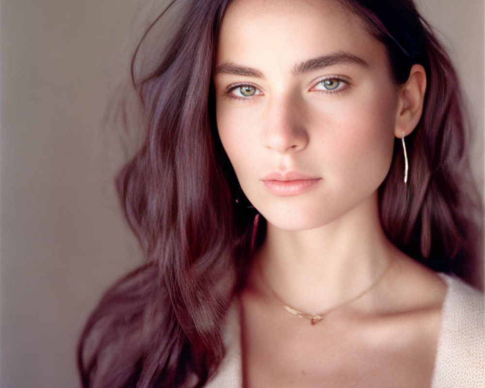 Portrait of Woman with Long Wavy Hair and Striking Blue Eyes