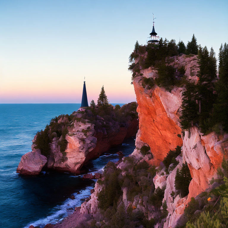 Lighthouse on rugged cliff at dusk overlooking ocean and trees.