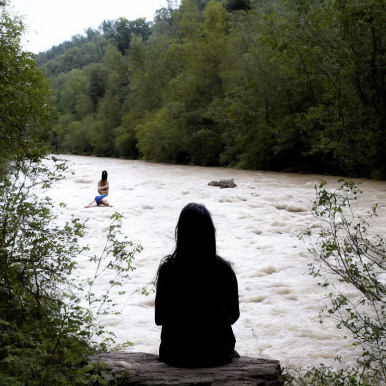 Two individuals in nature by a fast-flowing river surrounded by greenery