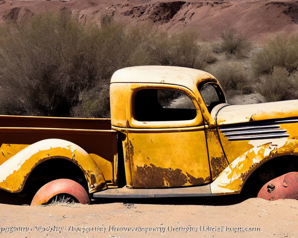 Abandoned vintage yellow pickup truck in desert setting