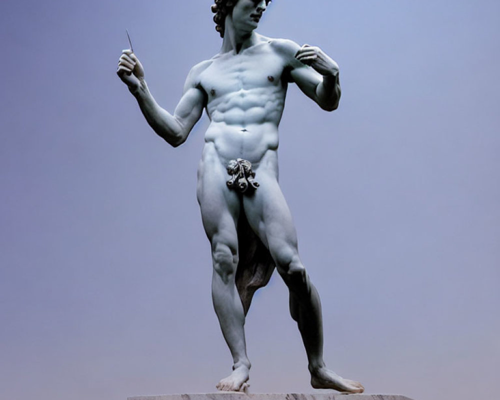 Detailed marble statue of David with sling against pale sky