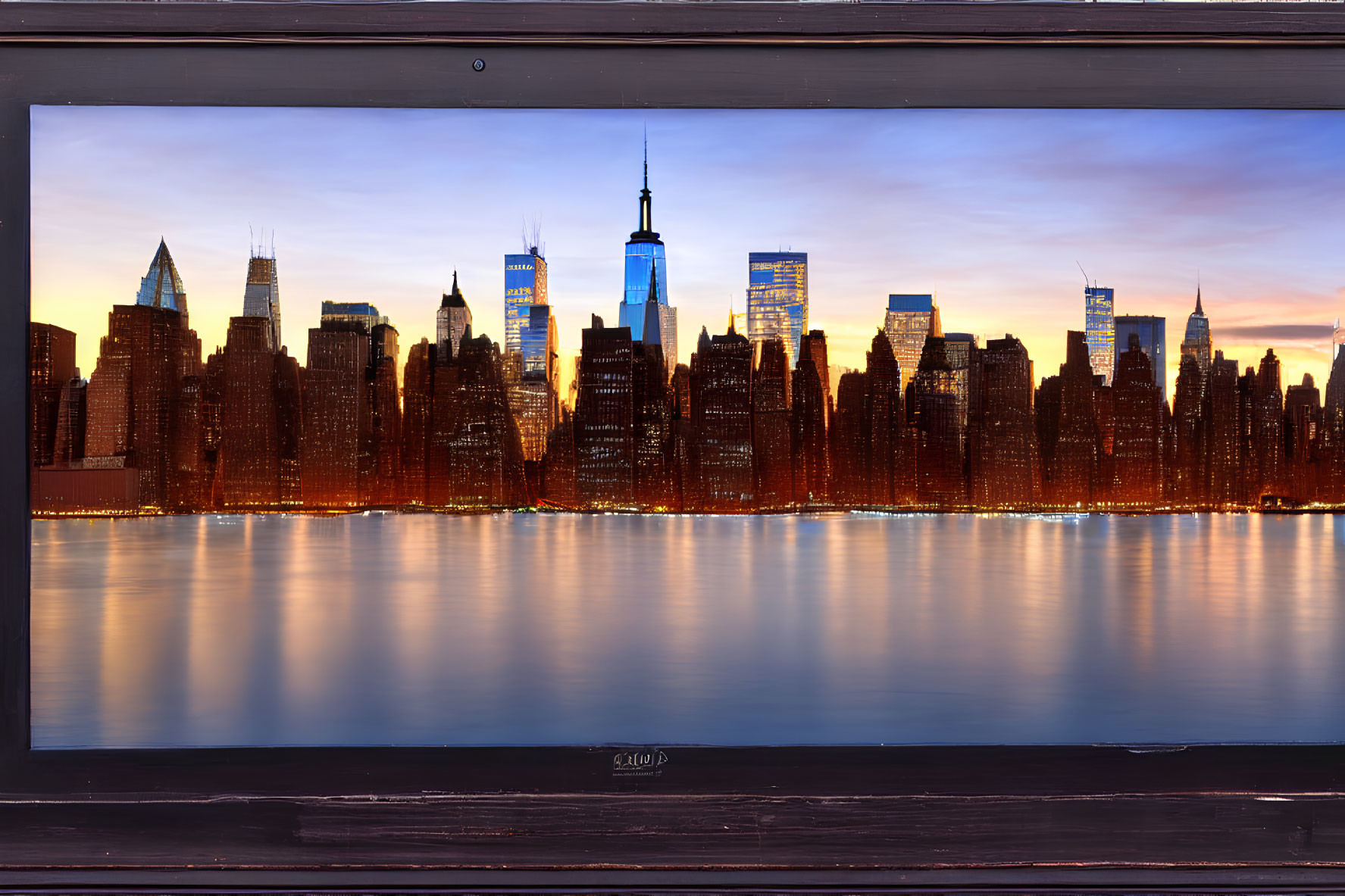 City skyline sunset reflections on water with wooden guardrail.