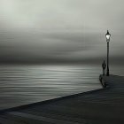 Foggy suspension bridge over calm river with street lamps and wooden walkway