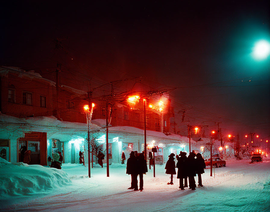 Group of People Waiting at Snowy Night Street Corner