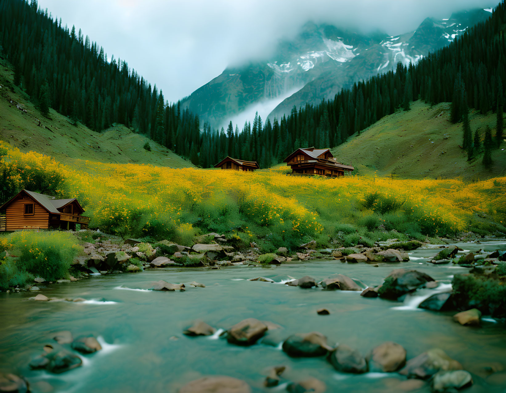 Mountain landscape with river, log cabins, wildflowers, and mist-covered peaks